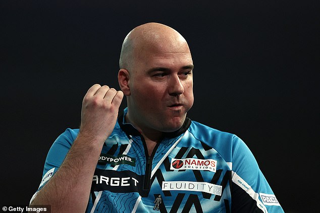 Rob Cross appears to make an obscene gesture midway through his World Darts Championship clash with Scott Williams at Ally Pally, before losing the second round tie.