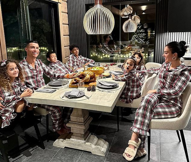 Footballers at Christmas! Stars enjoy the festivities with WAGs and children as Cristiano Ronaldo, Lionel Messi and Bernardo Silva pose calmly before the storm ahead of the Boxing Day games.