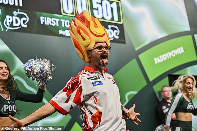 Australian darts star Damon Heta throws a NINE-DARTER, the pinnacle of the sport, resulting in a £60,000 payout to a random fan in the crowd at Ally Pally.