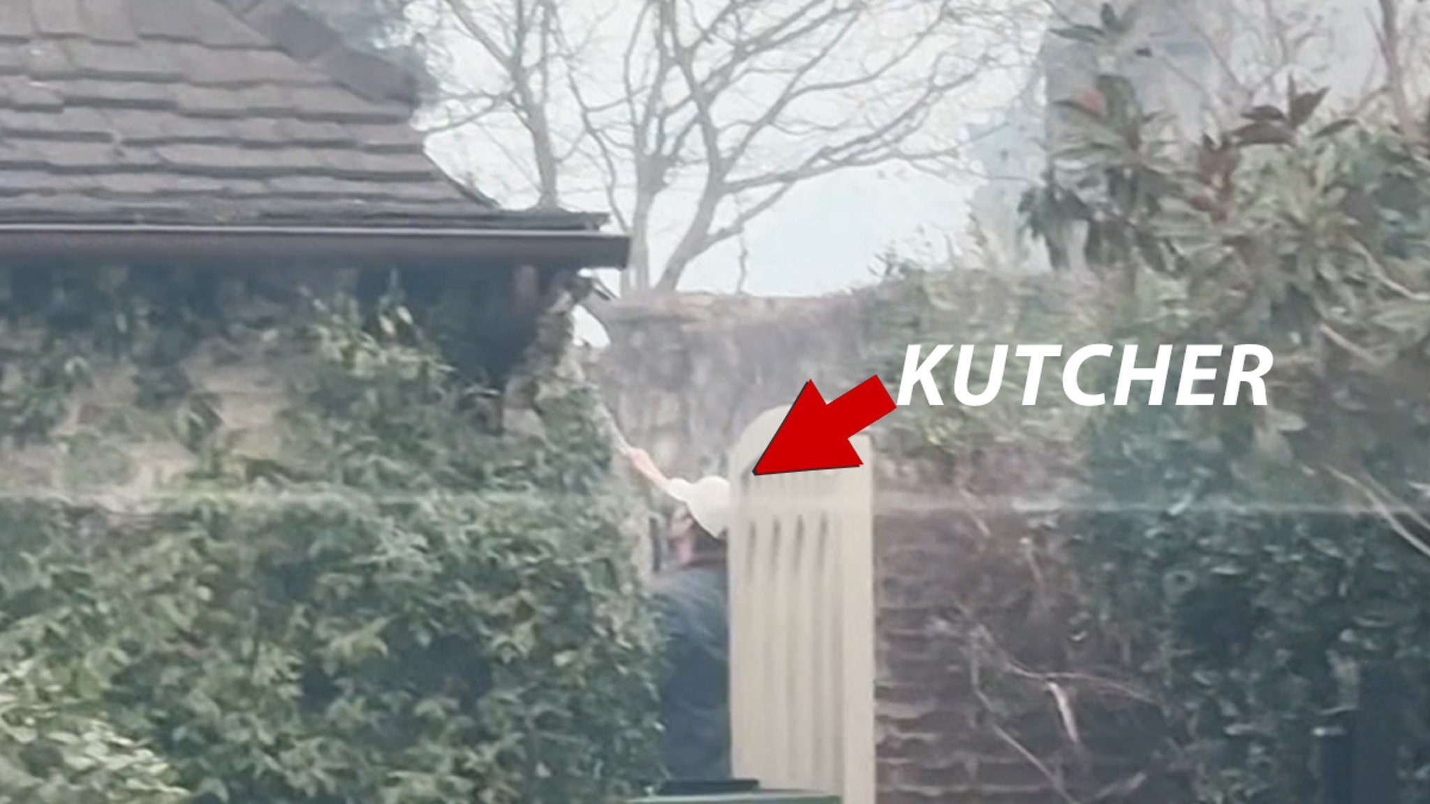 Ashton Kutcher tries to protect a friend's house from a forest fire with a garden hose