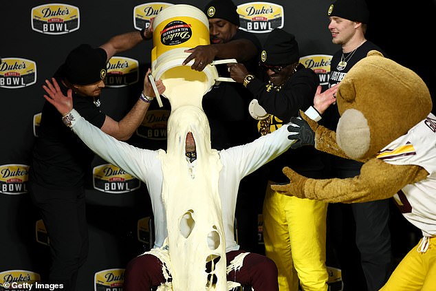 Disgusting moment: 'Secret celebrity' gives college football coach mayonnaise bath after bowl win