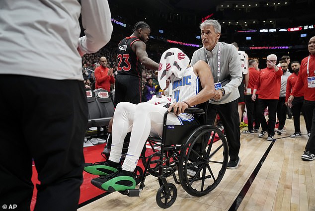 NBA player Jalen Suggs is wheeled off the court after suffering an agonizing non-contact back injury.