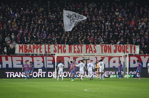 Kylian Mbappé is criticized by SM Caen fans who accuse their Real Madrid star owner of using the Ligue 2 club as a 'toy' after the controversial sacking of their coach.