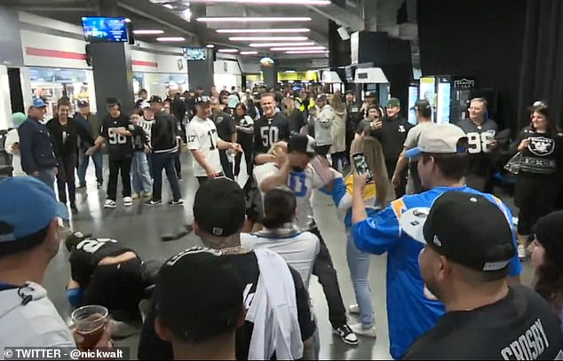 TV interview interrupted by shocking fan fight at Raiders-Chargers…as woman in boots tramples man