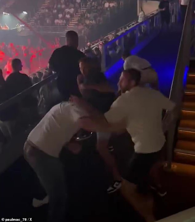 Watch the moment a fierce fight breaks out in the crowd at Australian world champion Jai Opetaia's boxing title fight.