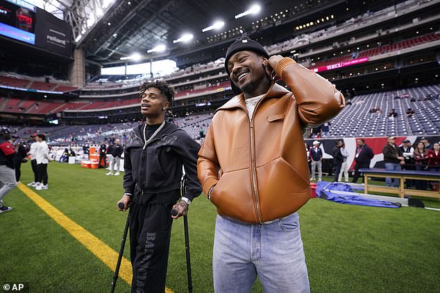 Tank Dell cheers on Houston Texans in playoff game against Chargers on crutches after horrific knee injury against Chiefs