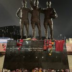 Man United fans pay tribute to Denis Law outside Old Trafford, as fans place scarves and flowers next to his statue after his death aged 84.