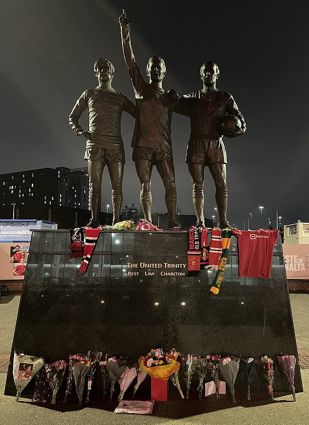 Man United fans pay tribute to Denis Law outside Old Trafford, as fans place scarves and flowers next to his statue after his death aged 84.