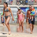 Great Geatoff Huegill swimming a very fit figure on a rare public excursion with their children in Bondi Beach