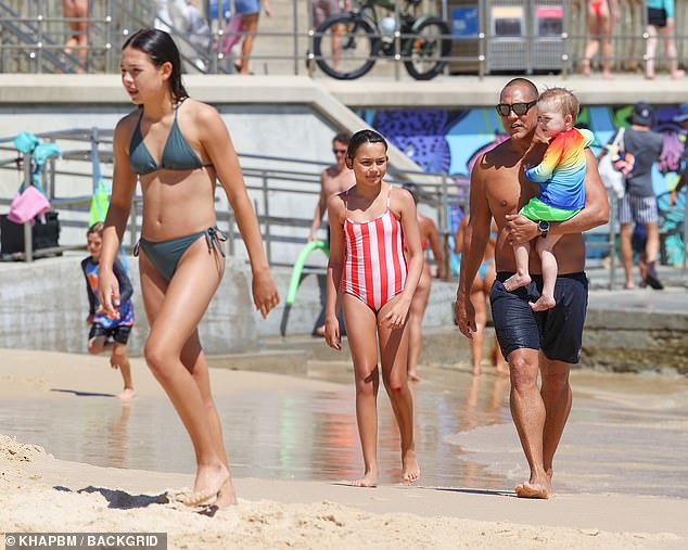 Great Geatoff Huegill swimming a very fit figure on a rare public excursion with their children in Bondi Beach