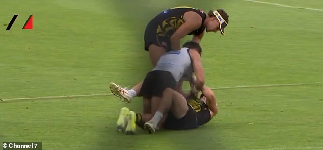 Shocking moment: Richmond's senior star is immobilized on the floor by a teammate during a fight in a heated training field