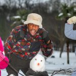 Ludacris builds a snowman with children in Atlanta