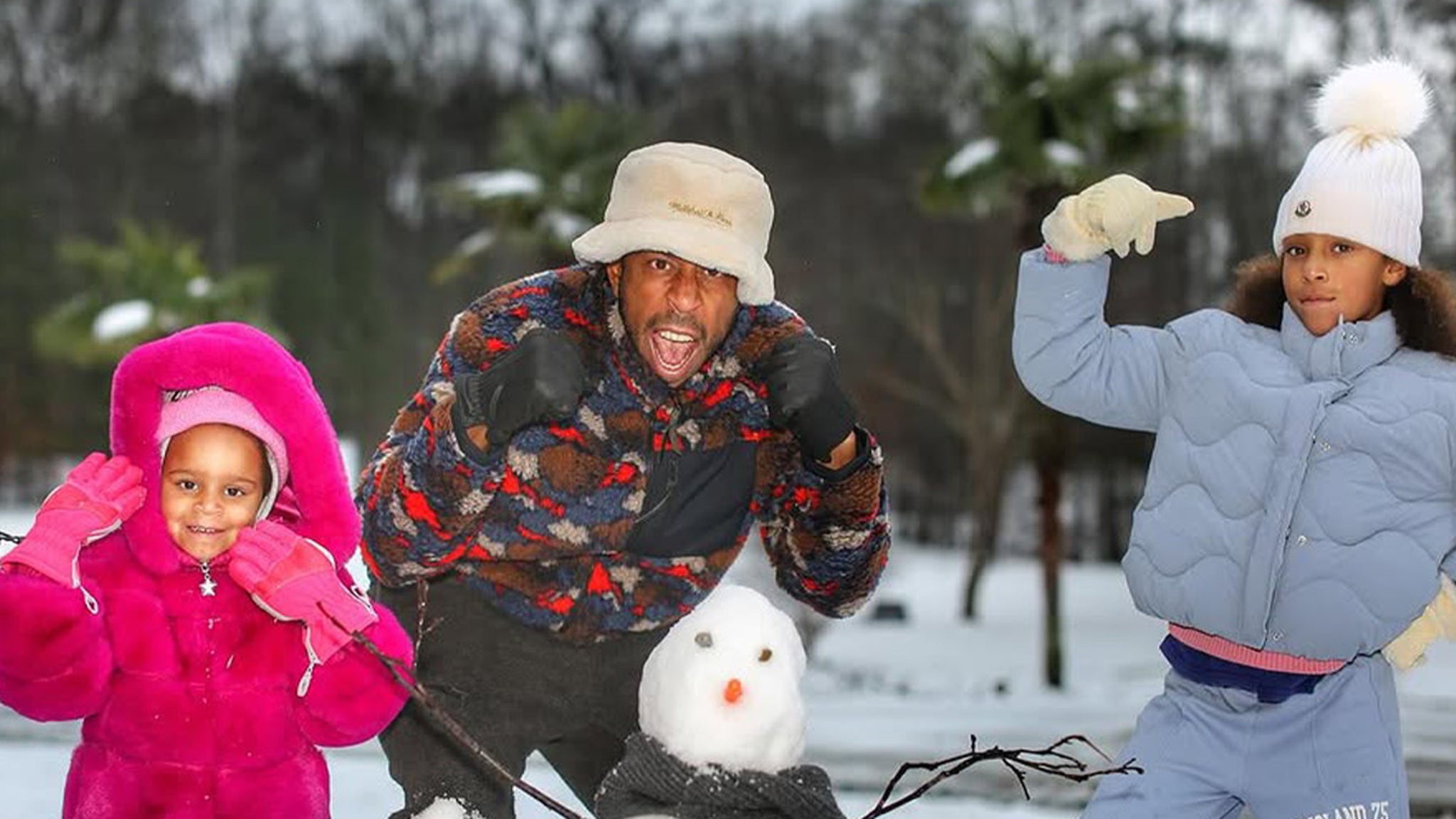 Ludacris builds a snowman with children in Atlanta