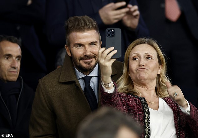 David Beckham poses for photos with fans while he sees the former PSG team face Liverpool in the Paris Champions League clash